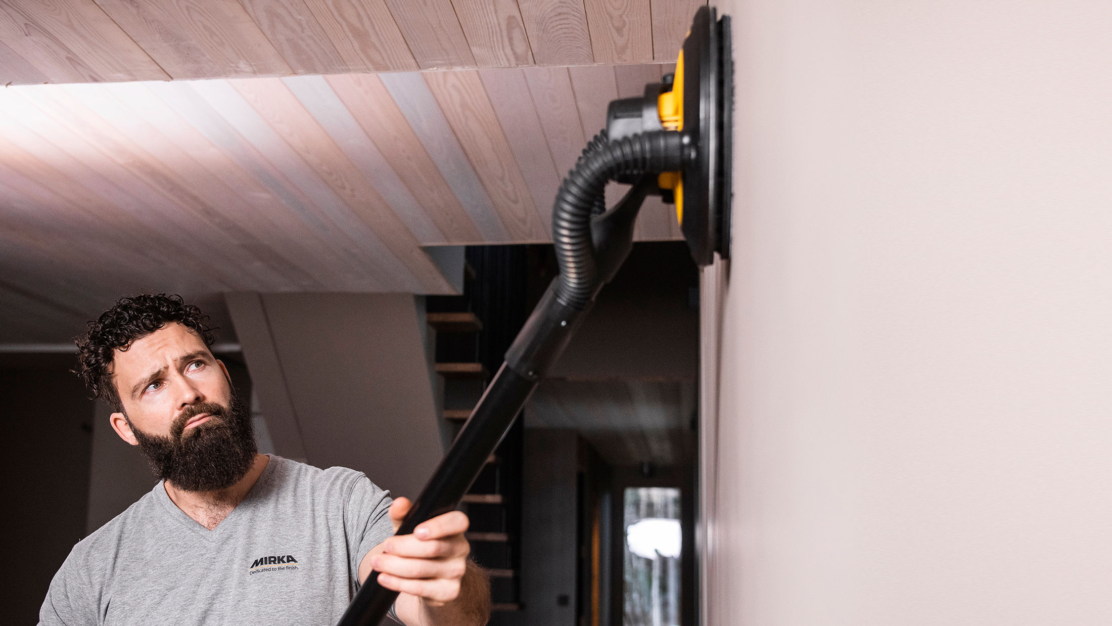 Sanding walls deals with electric sander