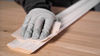 Hand sanding profiles using Mirka Goldflex soft abrasive.