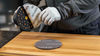 Hand applying Mirka Mirlon Total abrasive to a DEROS sander.