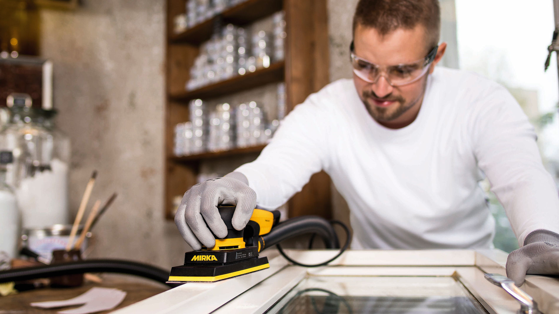 Sand wooden window and door frames with Mirka® DEOS Mirka