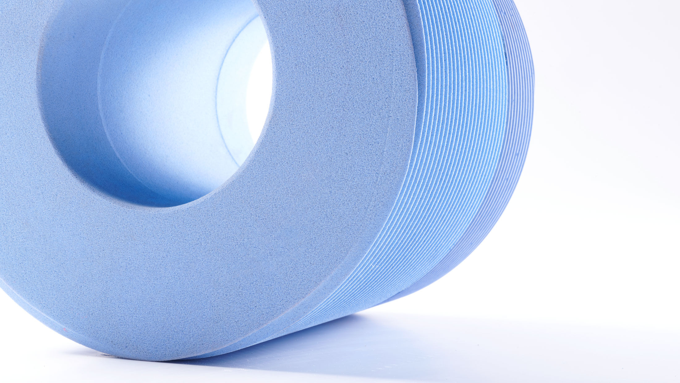 Representatives from Mirka Abrasives Germany holding a bonded grinding wheel