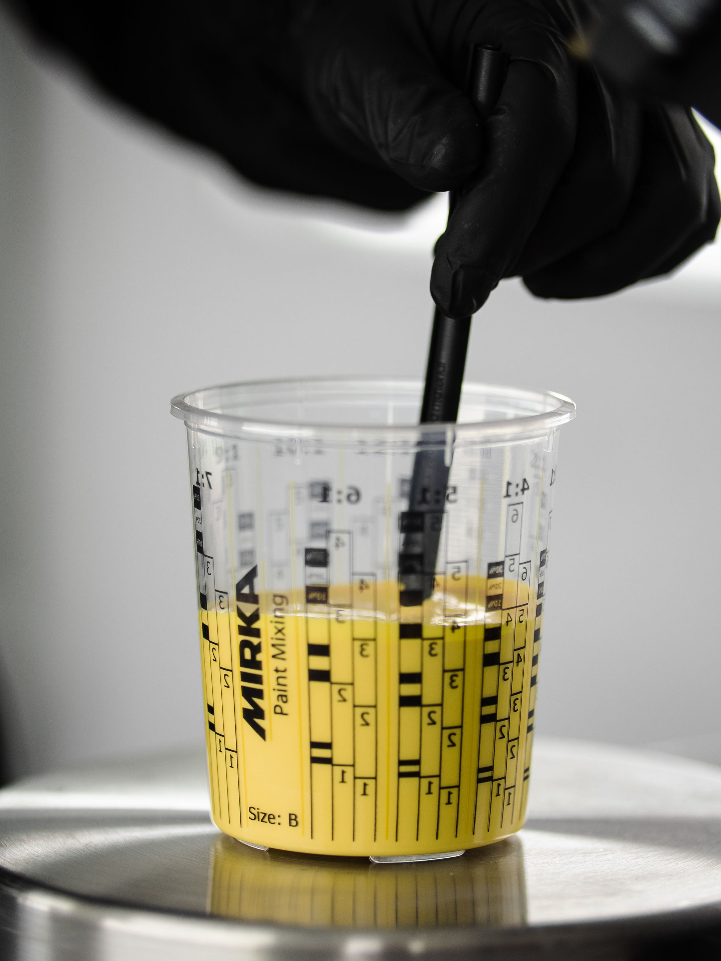 Measuring yellow paint in a PPS cup