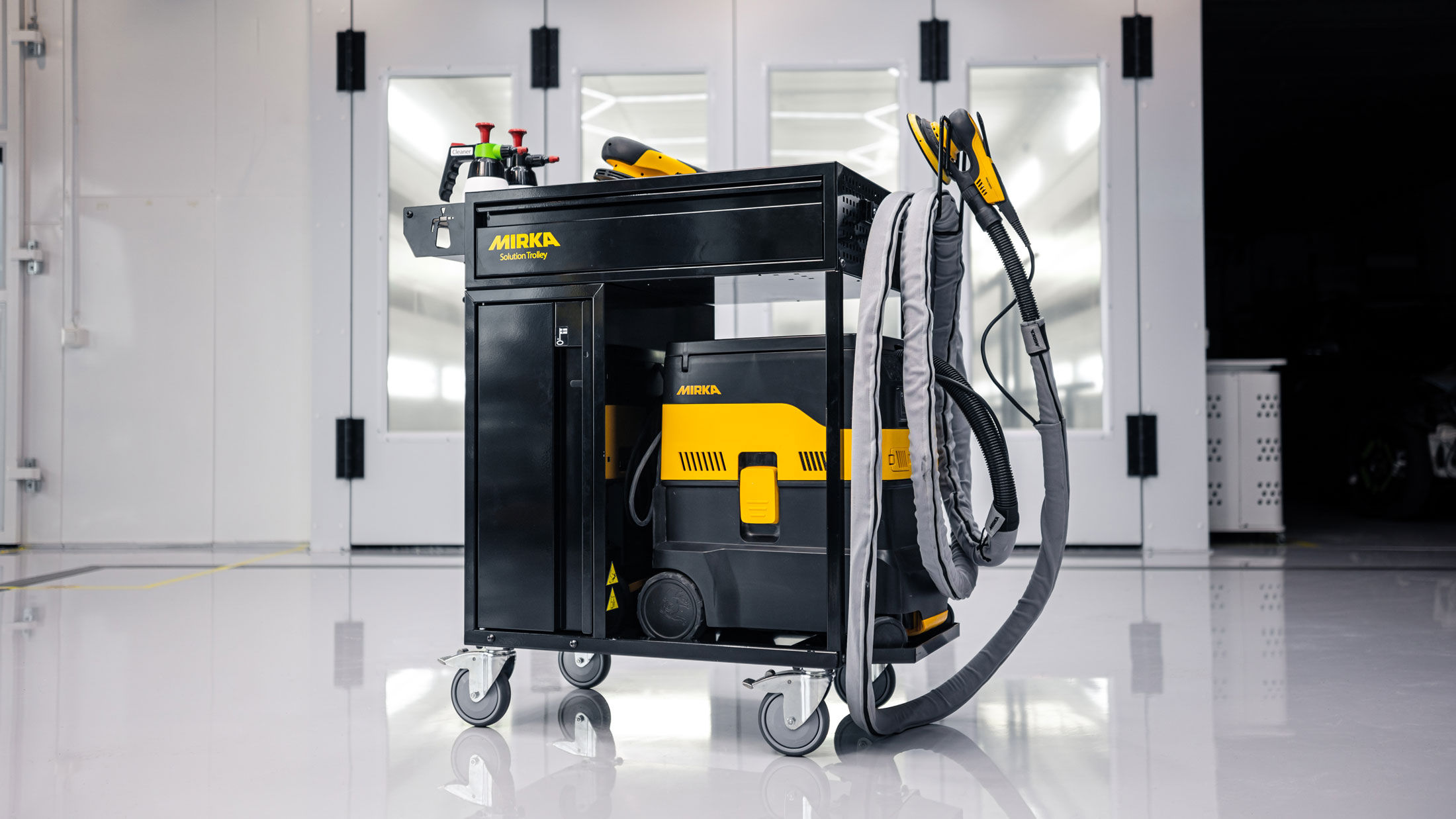Mirka Solution Trolley II tool trolley in a clean white body shop.