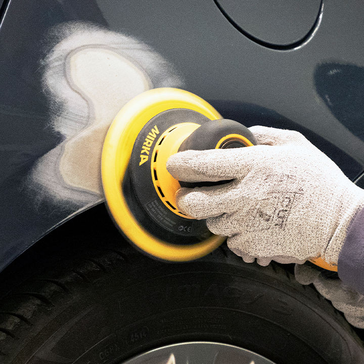 Sanding car quarter panel with power tool