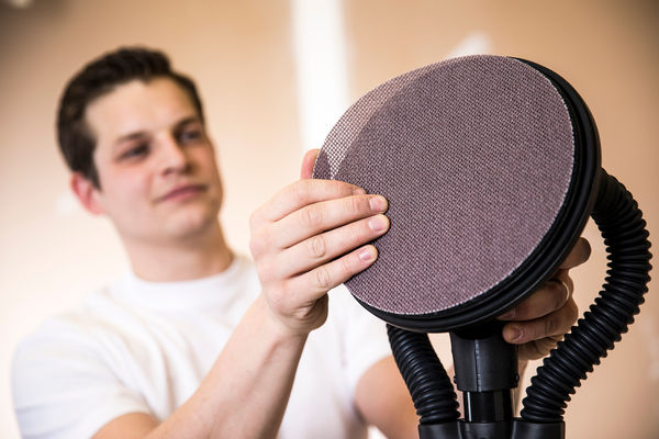 Mirka Abranet Ace 9 inch Grip sanding disc being attached to a 9 inch sanding head for wall and ceiling sanding