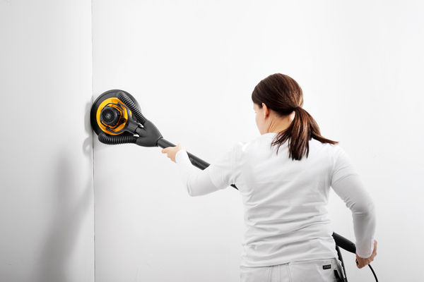 Mirka Abranet Ace 9 inch Grip sanding disc used on a wall with a long reach sander during surface preparation work